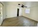 A bedroom with white walls, wood-look flooring, a ceiling fan and a window that provides natural light at 15040 Sw 29Th St, Ocala, FL 34481