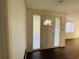 Bright foyer with hardwood floors featuring a door with decorative glass panels at 15040 Sw 29Th St, Ocala, FL 34481
