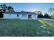 Charming single-story home featuring a bright red front door and spacious green lawn at 15040 Sw 29Th St, Ocala, FL 34481