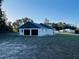 Two-car garage with black doors; an extra space is attached to the side at 15040 Sw 29Th St, Ocala, FL 34481