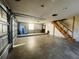 Spacious garage with concrete floor, stairs, and a partially open garage door at 15040 Sw 29Th St, Ocala, FL 34481