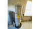 Close-up of a newer AO Smith hot water tank with an energy guide sticker in the basement utility area at 15040 Sw 29Th St, Ocala, FL 34481