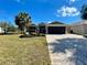 Charming single-story home with a well-manicured lawn, mature landscaping and brick paver driveway at 16191 Sw 12Th Ter, Ocala, FL 34473