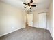 Carpeted bedroom with a ceiling fan and double door closet provides a comfortable space at 17159 Sw 44Th Cir, Ocala, FL 34473