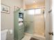 Bathroom featuring a glass door shower and a cabinet for linen storage at 1731 Se Clatter Bridge Rd, Ocala, FL 34471