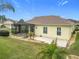 Expansive backyard featuring a well-maintained lawn, mature trees, and a screened lanai for outdoor living at 17608 Se 121St Cir, Summerfield, FL 34491