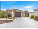 Inviting home featuring a well-manicured lawn, paver driveway, and attached garage at 1914 Adair Ln, The Villages, FL 32162