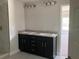 Double vanity bathroom showcasing dual sinks and dark cabinetry, perfect for a Gathering or couple at 2 Dogwood Crse, Ocala, FL 34472