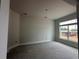 A large bedroom with smooth concrete flooring and a large window allowing natural light at 2 Dogwood Crse, Ocala, FL 34472