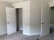 Bright bedroom with neutral walls, carpet, and a closet with stylish double doors at 2 Dogwood Crse, Ocala, FL 34472