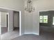 Open dining area with chandelier, view to other living spaces and large windows at 2 Dogwood Crse, Ocala, FL 34472