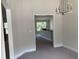 Dining room with chandelier and view into kitchen with counter seating and natural light at 2 Dogwood Crse, Ocala, FL 34472