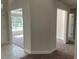Hallway that connects to a carpeted living room and other areas, with doorways visible at 2 Dogwood Crse, Ocala, FL 34472