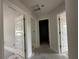 Hallway with multiple doors and neutral paint at 2 Dogwood Crse, Ocala, FL 34472