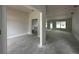 Open living space showcasing smooth concrete flooring and an abundance of natural light at 2 Dogwood Crse, Ocala, FL 34472