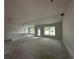 Open living space featuring smooth concrete flooring, large windows, and high ceilings at 2 Dogwood Crse, Ocala, FL 34472