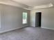 A spacious main bedroom with a trey ceiling and a private door leading to the Primary bathroom at 2 Dogwood Crse, Ocala, FL 34472