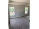 Carpeted main bedroom with windows offering natural light at 2 Dogwood Crse, Ocala, FL 34472