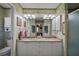 Well-lit bathroom with double sinks, granite countertop, and a walk-in shower at 2538 Privada Dr, The Villages, FL 32162