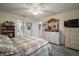 Inviting bedroom with a view of the ensuite bathroom featuring light and airy decor at 2538 Privada Dr, The Villages, FL 32162