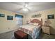 Comfortable bedroom featuring a queen bed, soft lighting, and neutral decor at 2538 Privada Dr, The Villages, FL 32162