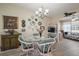 Cozy dining room features a glass table, wicker chairs, and decorative wall accents at 2538 Privada Dr, The Villages, FL 32162