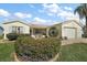 Charming single-story home features a screened porch and well-maintained landscaping under a bright, partly cloudy sky at 2538 Privada Dr, The Villages, FL 32162