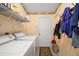 Well-equipped laundry room with washer, dryer, shelving, and storage at 2538 Privada Dr, The Villages, FL 32162