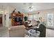 Inviting living room is enhanced by a decorative display cabinet and large window offering a cozy atmosphere at 2538 Privada Dr, The Villages, FL 32162