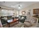 Comfortable living room with plush sofas, a ceiling fan and bright natural light creates a relaxing space at 2538 Privada Dr, The Villages, FL 32162