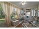 Enclosed patio area with comfortable seating, offering a relaxing outdoor space at 2538 Privada Dr, The Villages, FL 32162