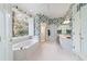 Bathroom showcasing a tub, shower, vanity, and floral wallpaper design at 2775 Sw 53Rd St, Ocala, FL 34471