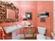 Elegant powder room featuring a pedestal sink, decorative mirror, and unique wallpaper at 2775 Sw 53Rd St, Ocala, FL 34471