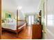 Bedroom featuring hardwood floors, a four-poster bed, and access to outdoor spaces at 2775 Sw 53Rd St, Ocala, FL 34471