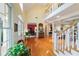 Bright foyer with hardwood floors, high ceilings, and elegant staircase leading to the upper level and living spaces at 2775 Sw 53Rd St, Ocala, FL 34471