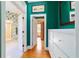 Hallway leading to a bathroom and bedroom, featuring hardwood floors and bright walls at 2775 Sw 53Rd St, Ocala, FL 34471