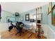Functional home office space with desk, chair, exercise bike, and ample natural light at 2775 Sw 53Rd St, Ocala, FL 34471