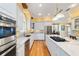 Open kitchen with white cabinets, granite countertops, stainless appliances, and hardwood floors at 2775 Sw 53Rd St, Ocala, FL 34471