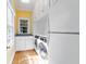 Well-equipped laundry room with washer, dryer, built-in cabinets, and natural light at 2775 Sw 53Rd St, Ocala, FL 34471