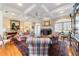 Elegant living room featuring a fireplace, coffered ceilings, hardwood floors, and comfortable seating arrangements at 2775 Sw 53Rd St, Ocala, FL 34471