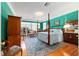 Spacious main bedroom features bold wall colors, a four-poster bed, and a seating area at 2775 Sw 53Rd St, Ocala, FL 34471
