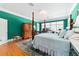 Spacious main bedroom featuring an antique armoire, four-poster bed and natural light at 2775 Sw 53Rd St, Ocala, FL 34471