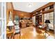 Traditional wood-paneled office with built-in bookshelves, a desk, and a window seat at 2775 Sw 53Rd St, Ocala, FL 34471