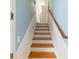 Bright staircase with wood treads, white risers, and light blue walls leading to the upper level at 2775 Sw 53Rd St, Ocala, FL 34471