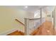 Elegant staircase featuring hardwood floors and white railings at 2775 Sw 53Rd St, Ocala, FL 34471