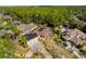 Aerial shot of house boasting a three-car garage, solar panels, and meticulous landscaping at 32 Allenwood Look, Ormond Beach, FL 32174