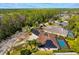 Overhead view of property featuring solar panels, a screened pool, and detailed landscaping at 32 Allenwood Look, Ormond Beach, FL 32174