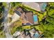 An aerial view of a single Gathering home with a screened in pool and solar panels at 32 Allenwood Look, Ormond Beach, FL 32174