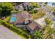 Aerial view of a pool home with solar panels near a lake at 32 Allenwood Look, Ormond Beach, FL 32174