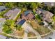 Aerial view of a single-Gathering pool home surrounded by mature trees at 32 Allenwood Look, Ormond Beach, FL 32174